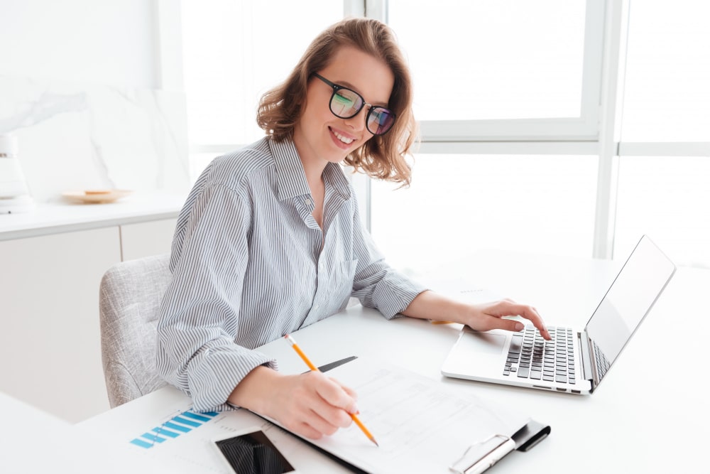 smiling-woman-glasses-working-with-documents
