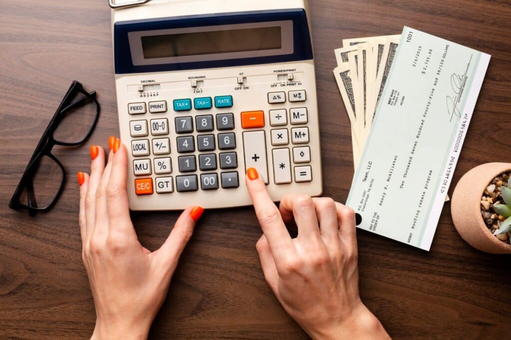 close-up-hands-using-calculator