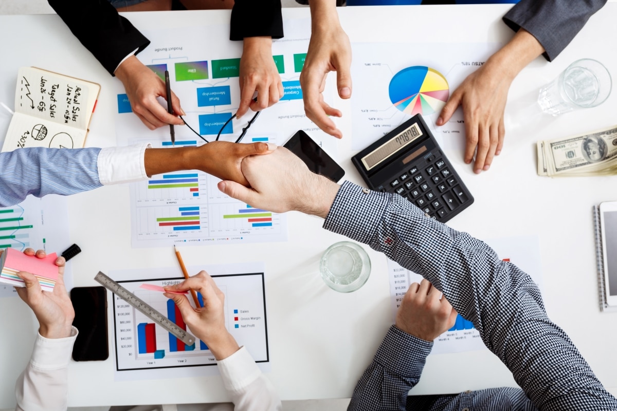 businessmen-hands-white-table-with-documents-drafts