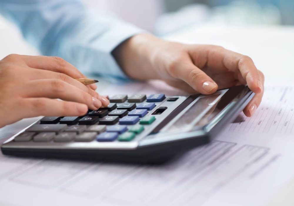 closeup-economist-working-counting-data-calculator