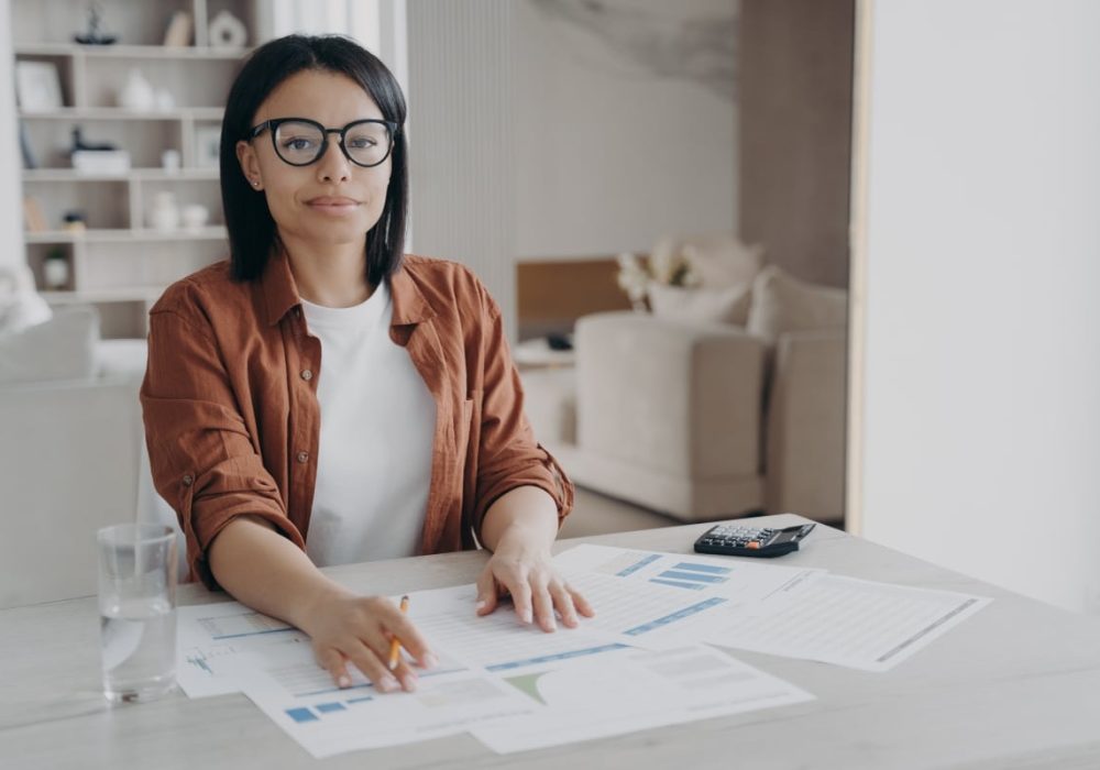 female-bookkeeper-freelancer-in-glasses-sitting-at-desk